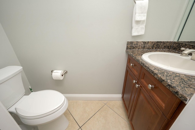 bathroom featuring toilet, tile floors, and vanity