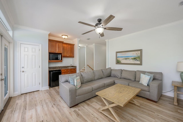 living room with crown molding, light hardwood / wood-style floors, ceiling fan, and sink