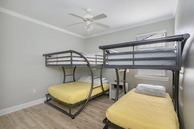 bedroom with light hardwood / wood-style floors, crown molding, and ceiling fan