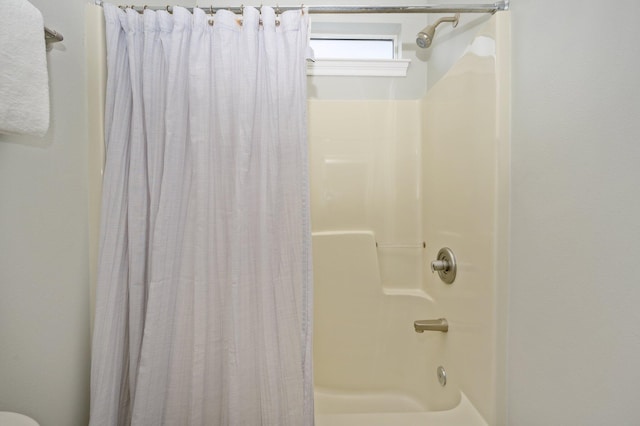 bathroom featuring shower / bathtub combination with curtain