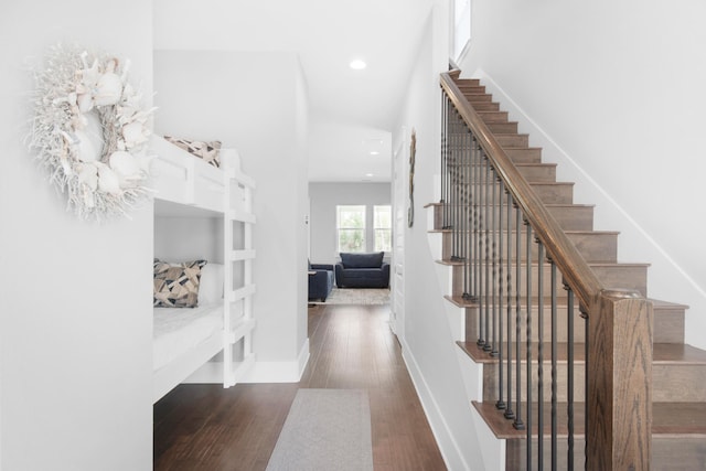 stairway with dark wood-type flooring