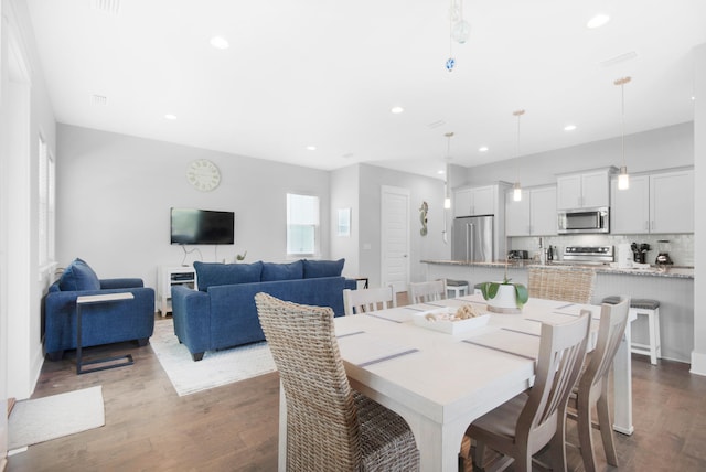 dining area with dark hardwood / wood-style flooring