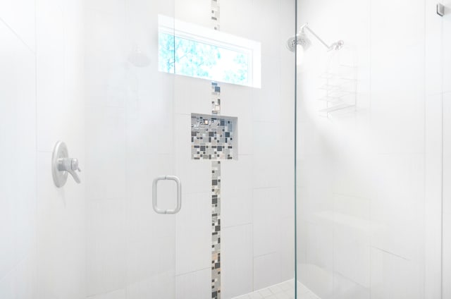 bathroom featuring a shower with shower door