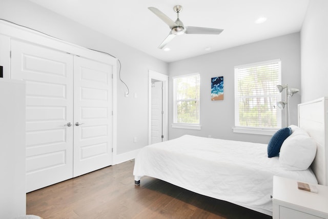 bedroom featuring a closet, wood-type flooring, and ceiling fan