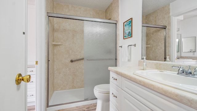 bathroom with toilet, oversized vanity, hardwood / wood-style floors, and a textured ceiling