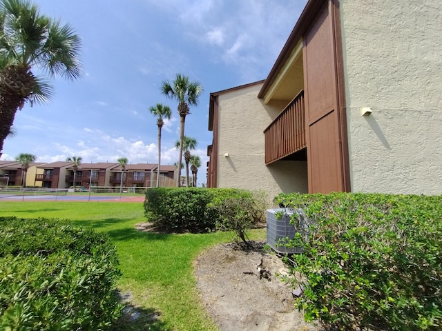 exterior space with a yard and a balcony