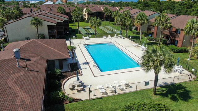 view of swimming pool with a yard and a patio