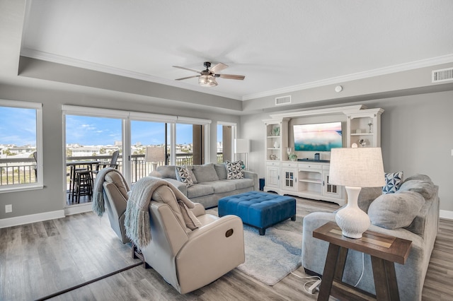 living room with ceiling fan, light hardwood / wood-style floors, and ornamental molding