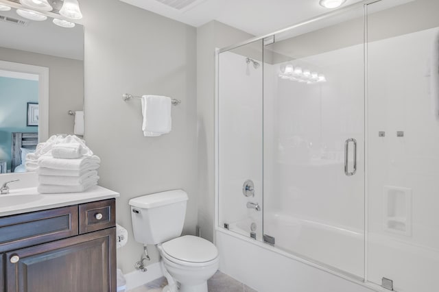 full bathroom featuring tile floors, toilet, shower / bath combination with glass door, and vanity