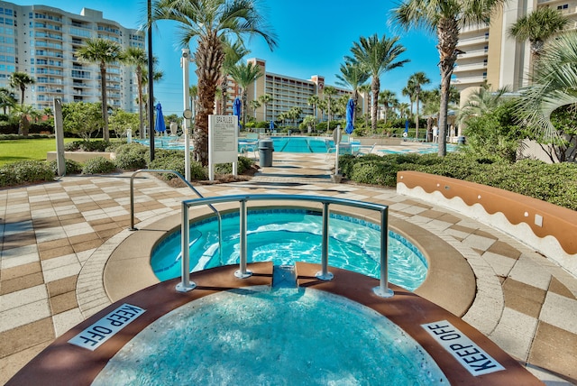 view of swimming pool with a community hot tub