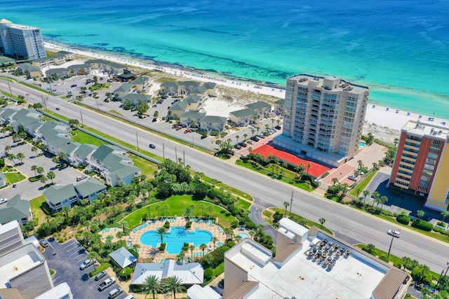 drone / aerial view featuring a beach view and a water view