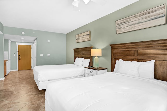 tiled bedroom featuring ceiling fan