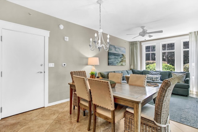 dining area with ceiling fan with notable chandelier and light tile patterned floors