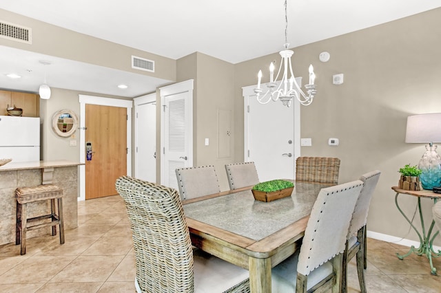 tiled dining space with a chandelier