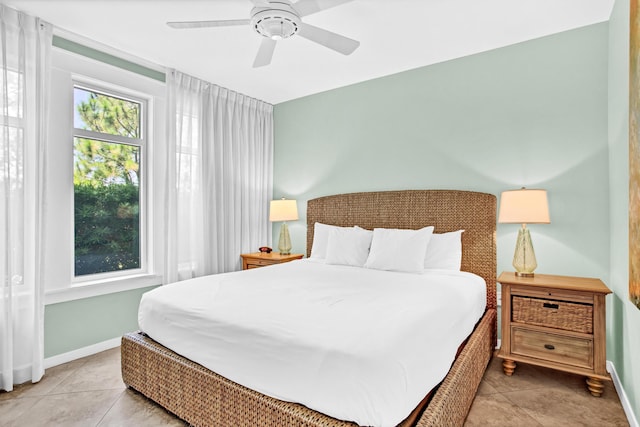 bedroom featuring light tile patterned floors and ceiling fan