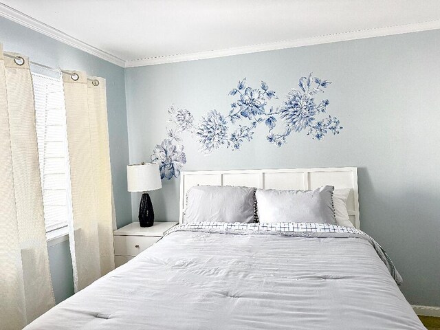 bedroom with multiple windows and crown molding