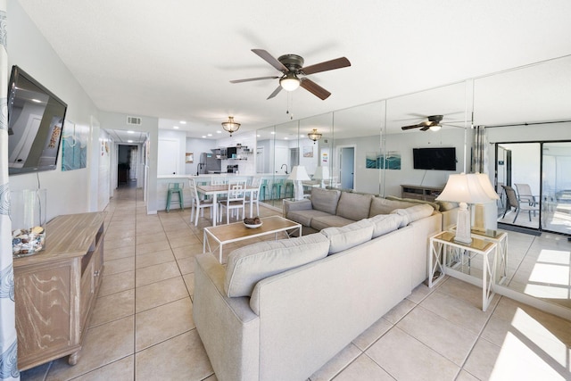 living room with ceiling fan and light tile floors