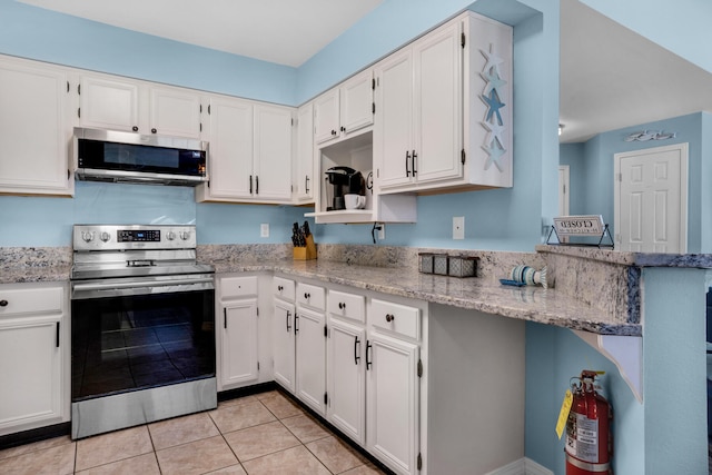 kitchen featuring white cabinets, stainless steel appliances, and light stone counters