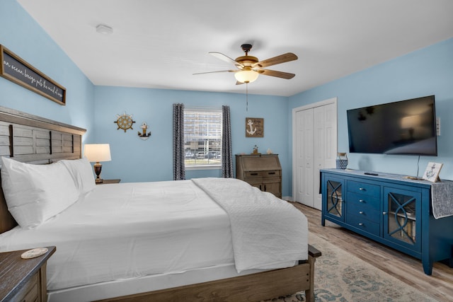 bedroom with a closet, ceiling fan, and light hardwood / wood-style floors