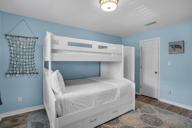 bedroom with dark hardwood / wood-style floors