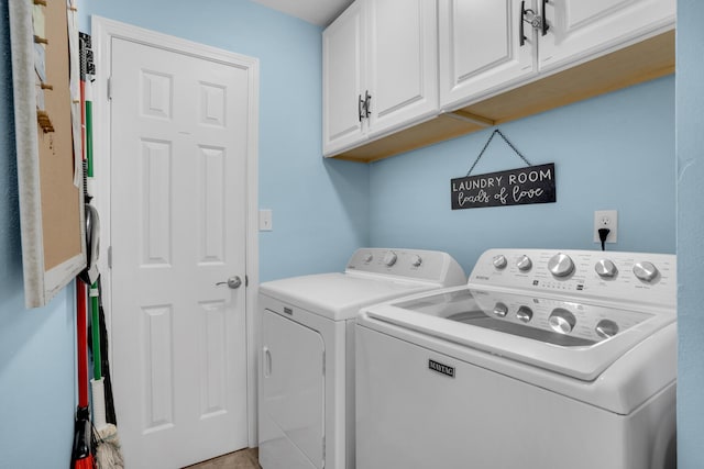 laundry room featuring washing machine and dryer and cabinets