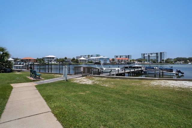 dock area with a water view and a lawn