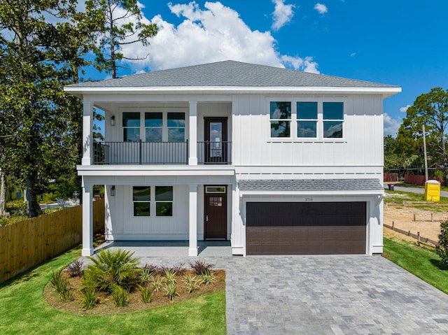 view of front of home with a balcony and a garage