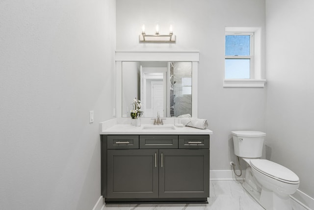 bathroom with vanity, toilet, and tile flooring