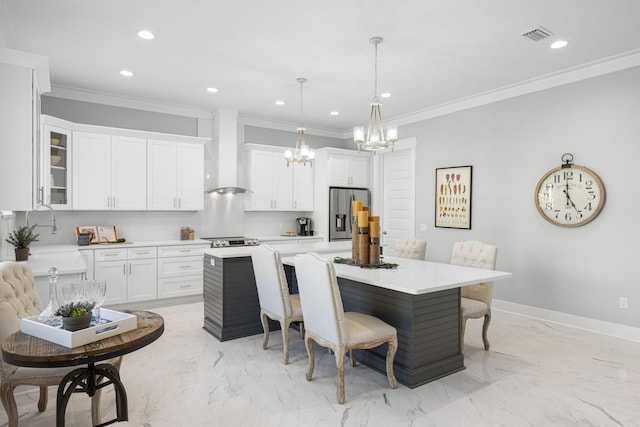 kitchen featuring custom exhaust hood, decorative light fixtures, a breakfast bar, stainless steel refrigerator with ice dispenser, and a kitchen island