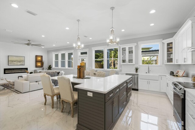 kitchen featuring white cabinets, sink, a kitchen island, and stainless steel appliances