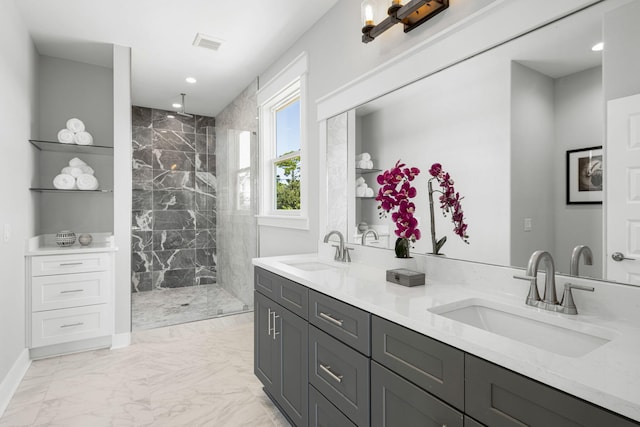 bathroom with double vanity, tile flooring, and a tile shower