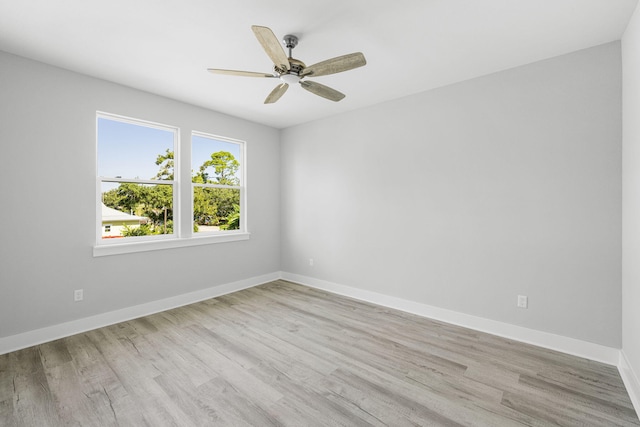 empty room with ceiling fan and light wood-type flooring