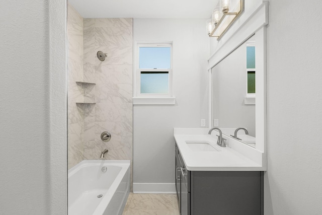 bathroom with tile flooring, vanity, tiled shower / bath combo, and a wealth of natural light