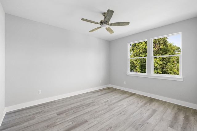 empty room featuring ceiling fan and light hardwood / wood-style floors