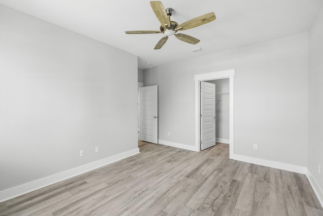 unfurnished bedroom with a closet, light hardwood / wood-style flooring, and ceiling fan