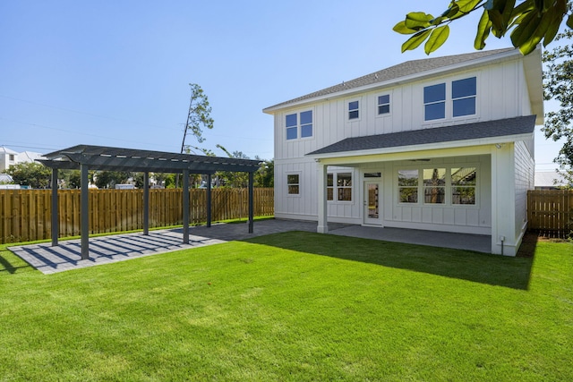 rear view of house featuring a patio area, a yard, and a pergola