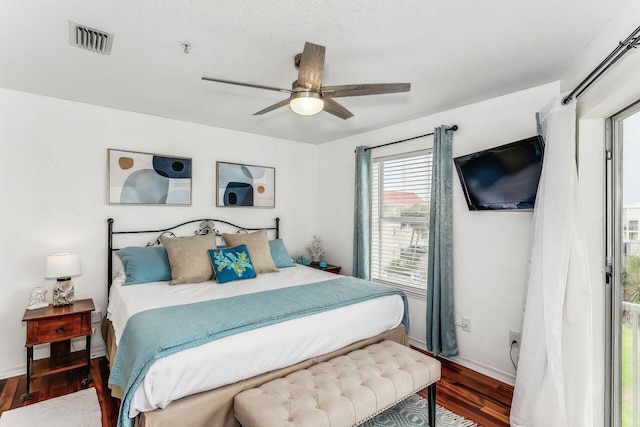 bedroom with ceiling fan and dark hardwood / wood-style floors