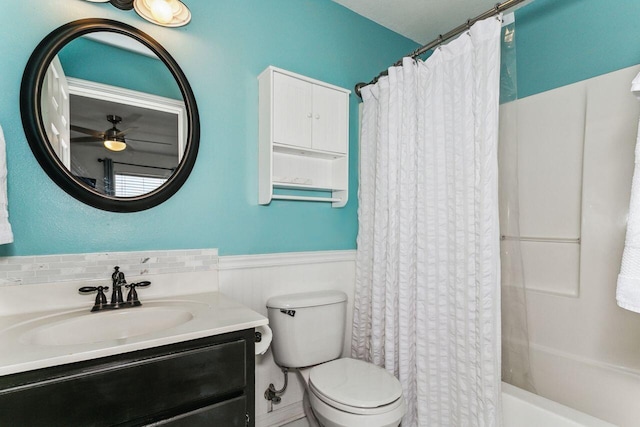 full bathroom with ceiling fan, vanity, shower / tub combo, and toilet