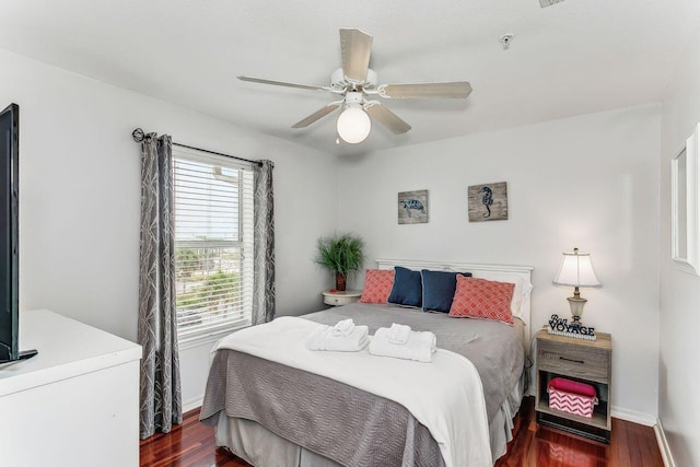 bedroom with ceiling fan and dark hardwood / wood-style flooring