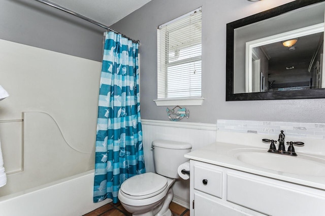 full bathroom featuring vanity with extensive cabinet space, shower / bath combination with curtain, and toilet