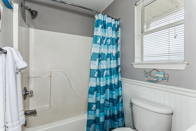 bathroom with toilet and shower / bath combo with shower curtain