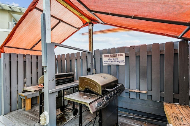 wooden deck featuring a grill