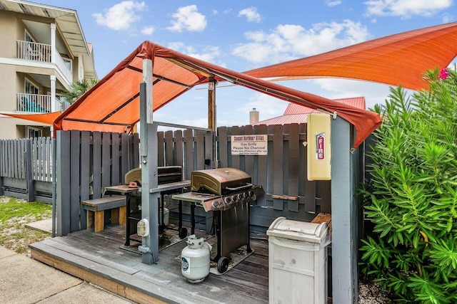 wooden terrace featuring area for grilling and a gazebo