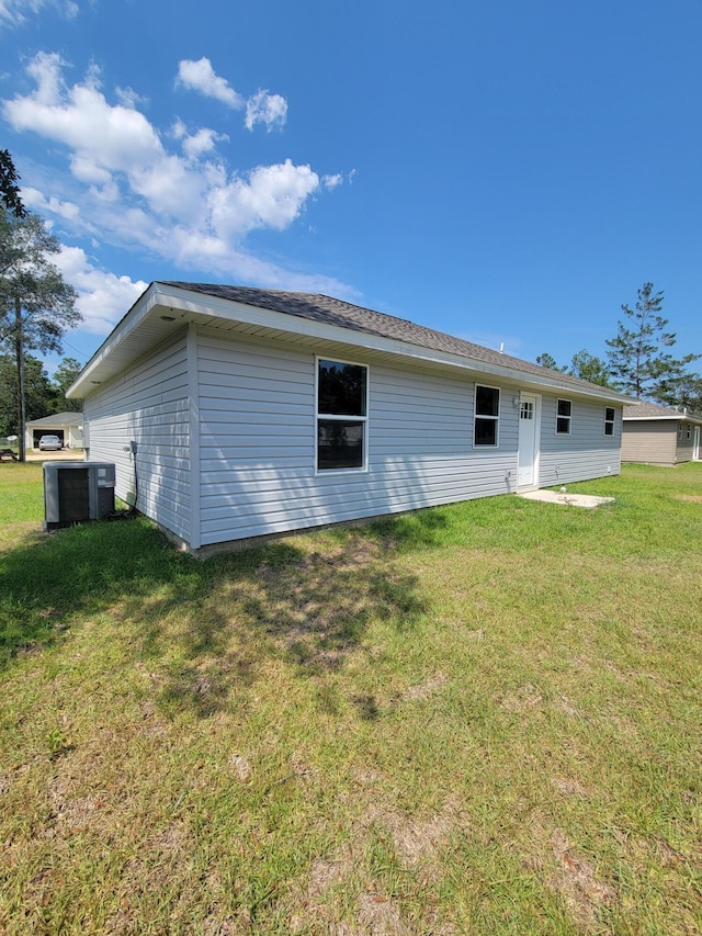 back of house with a lawn