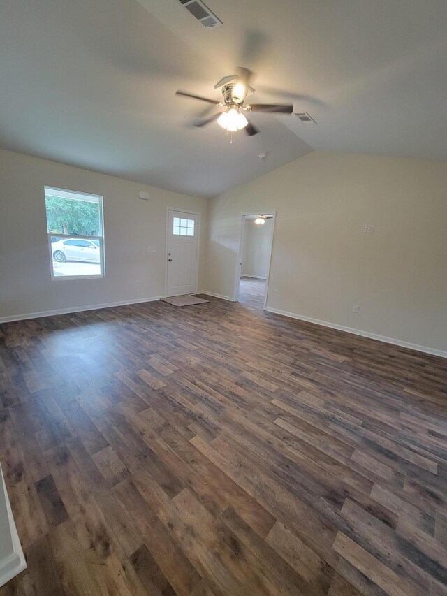 spare room with vaulted ceiling, dark wood-type flooring, and ceiling fan