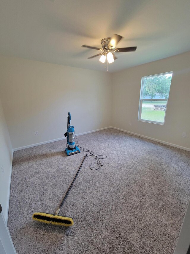 carpeted empty room with ceiling fan