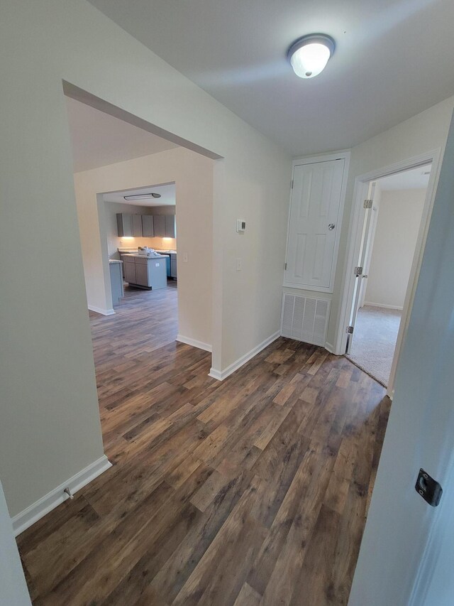 corridor with dark wood-type flooring