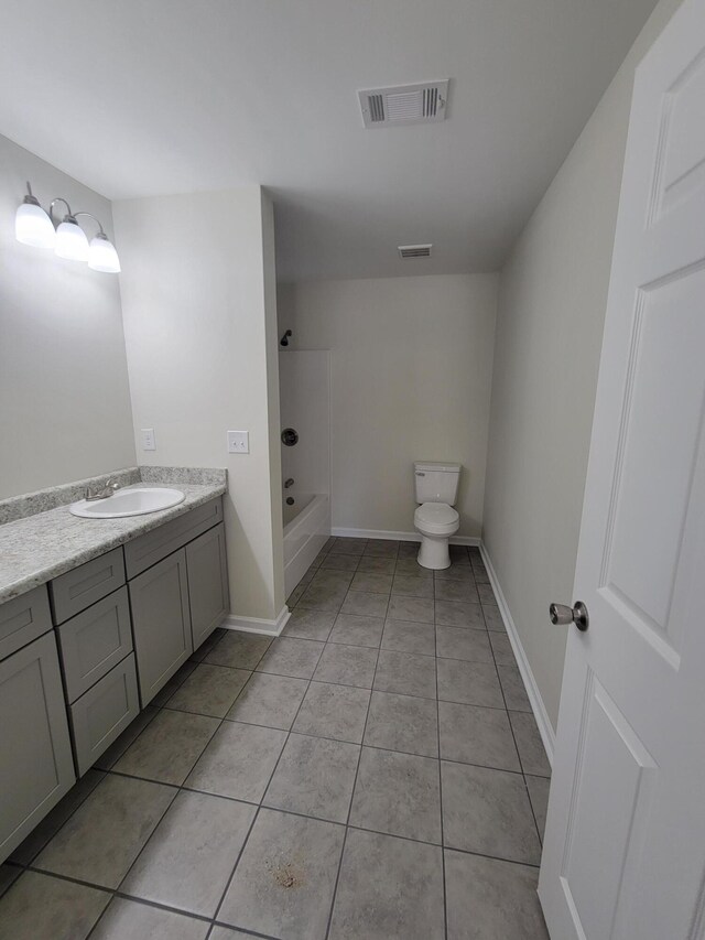 full bathroom with shower / washtub combination, vanity, tile patterned flooring, and toilet