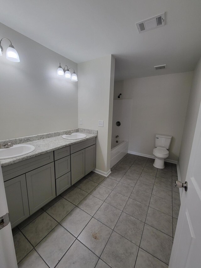 full bathroom with double sink vanity, toilet, and tile patterned flooring