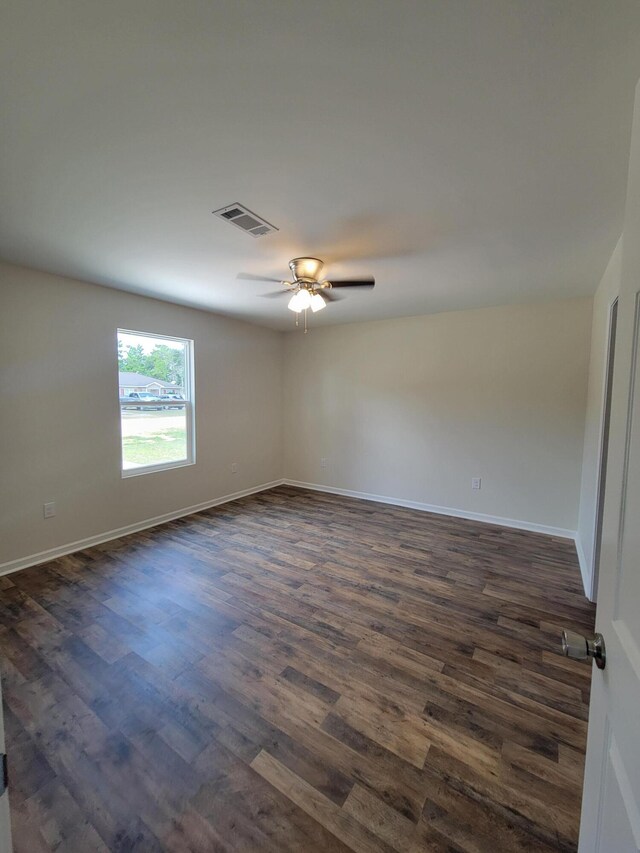 empty room with dark wood-type flooring and ceiling fan